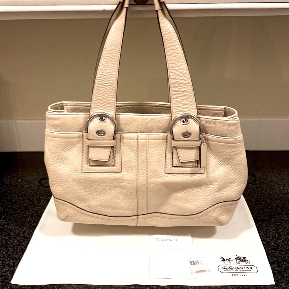 COACH sand colored pebble leather shoulder bag.